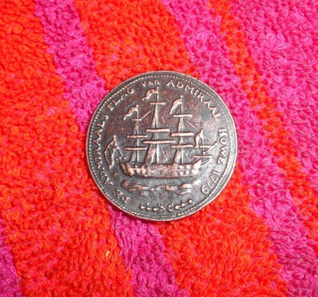 1 coin, believe it is copper with wreath under ship
