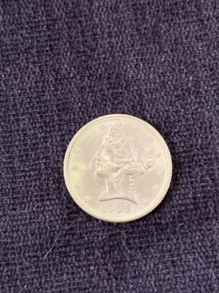 1905 gold 5 dollar coin. In VF condition.