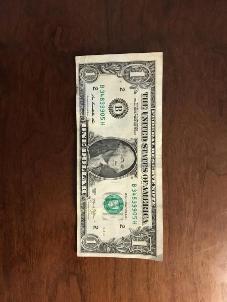 $1.00 bill series 2003 with uneven borders. Bill…