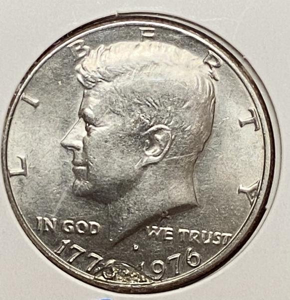 1776-1976 Kennedy half dollar with what looks like…