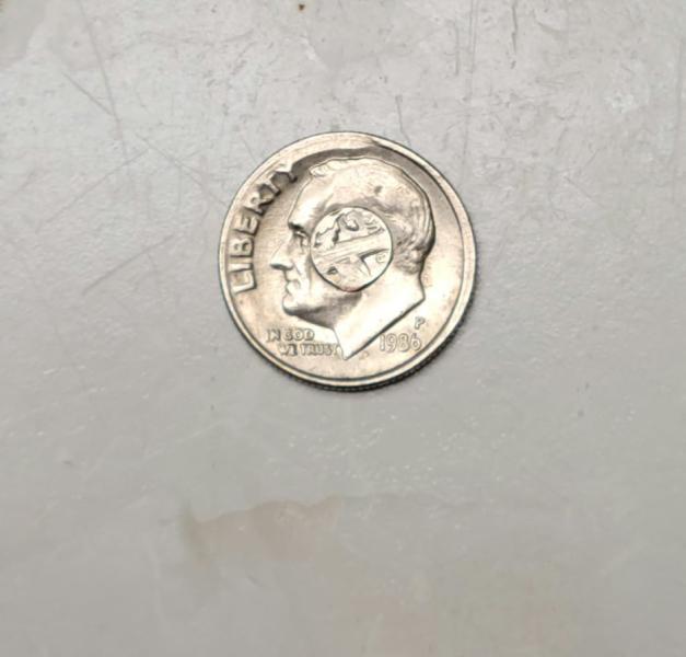1986p dime. Middle printed backwards and edging uneven.