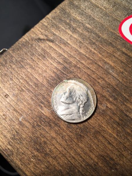 Nickel with penny imprinted in it