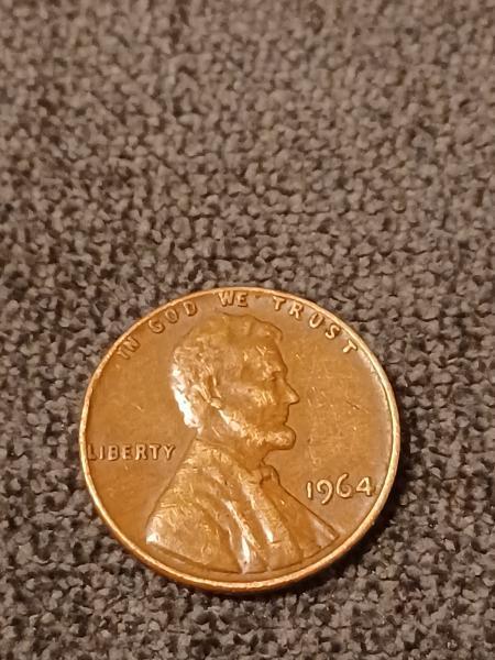 1964 penny. No mint mark. Smooth texture, almost…