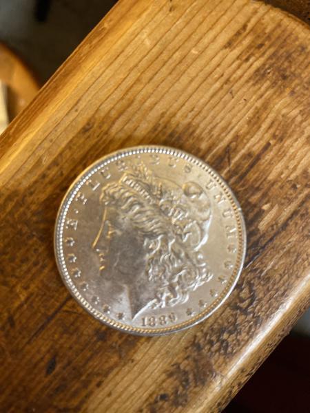 Silver ridged one dollar coin