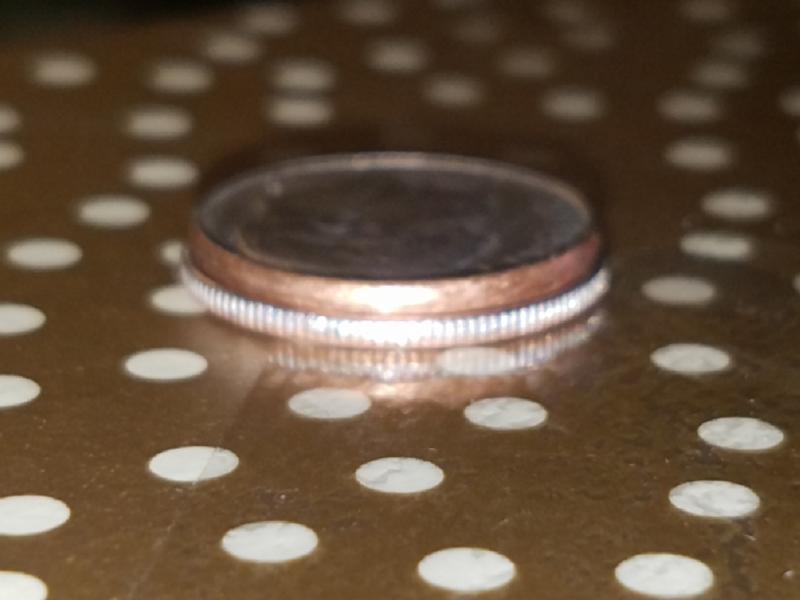 The dime is smaller than a regular dime.…