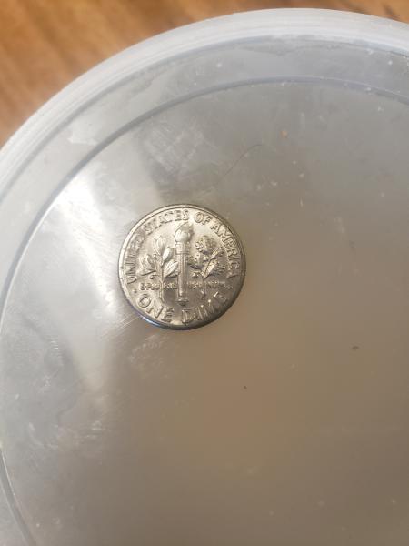 1987 dime with odd uneven surface across the…