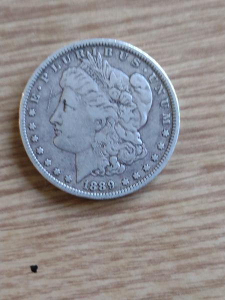 1889 Morgan silver dollar with large x mark
