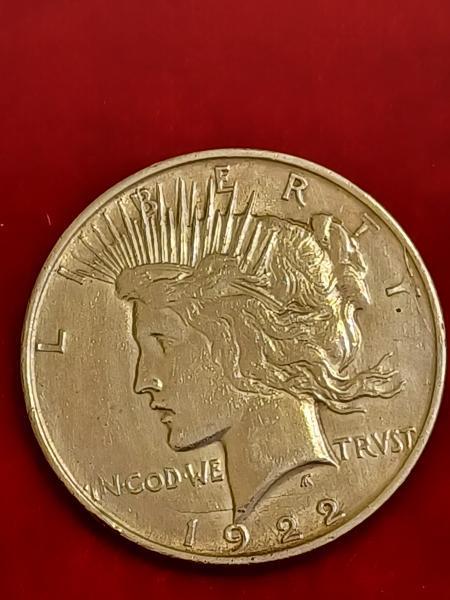This is a 1922 PEACE dollar, There is…