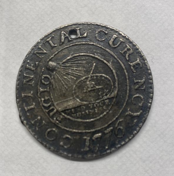 1776 continental coin. Has a small hole in it