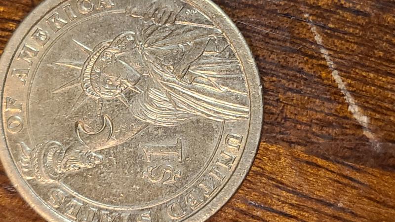 2007 James madison dollar coin with a crescent…