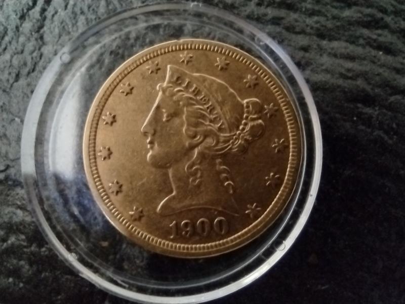 1900 no mint mark $5.00 gold coin appears…