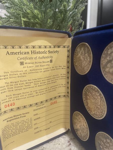 5 Morgan silver dollars with proof of authenticity