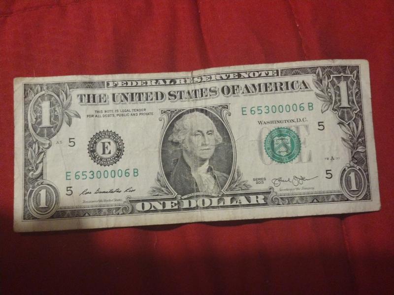 2013 Miscut dollar bill with quad zeros in…