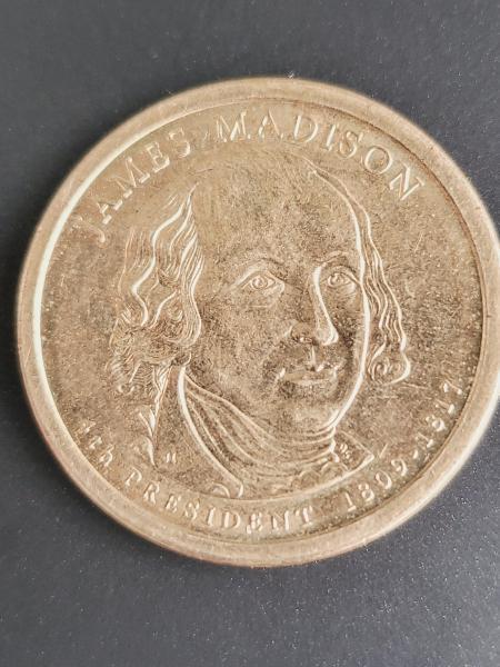 Three gold $1 coins and a silver $1 coin