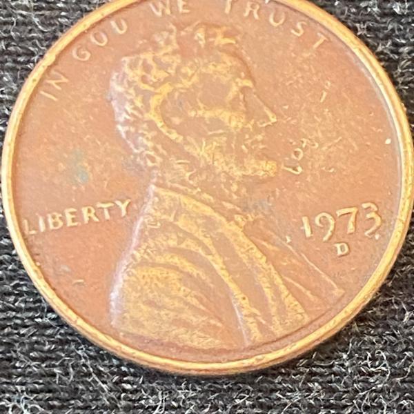 1973 Penny error on back in the word…