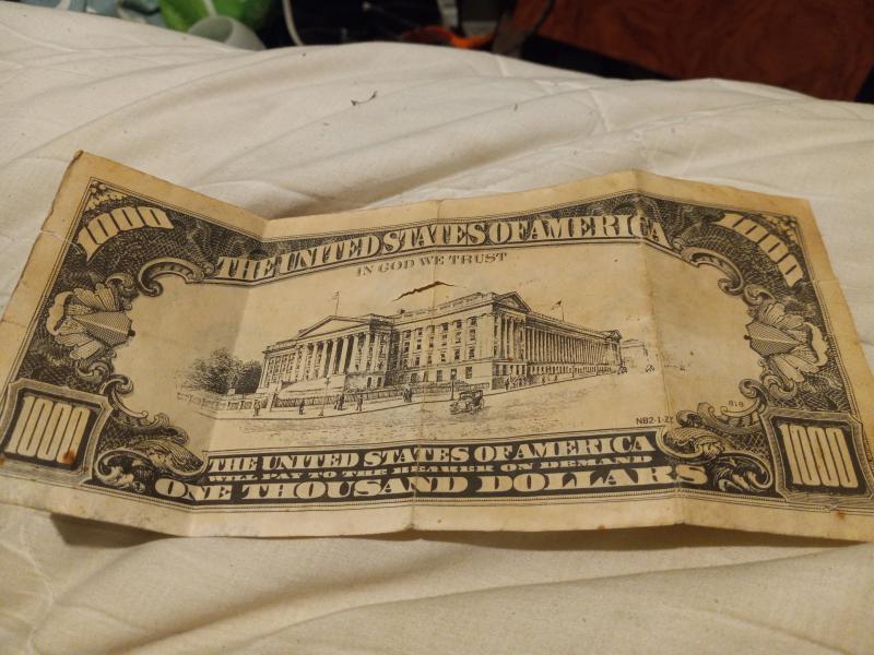 1934 $1000 has 4 creases and a few tears.