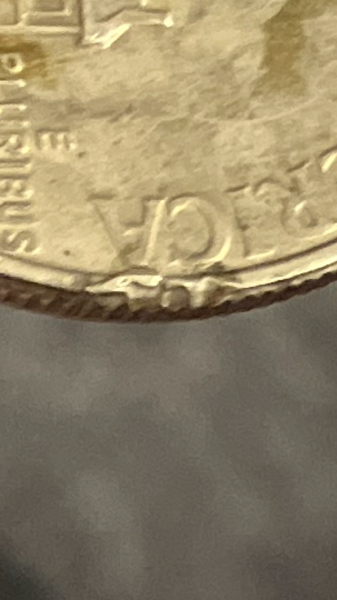 50 cent piece with cracks and mistakes