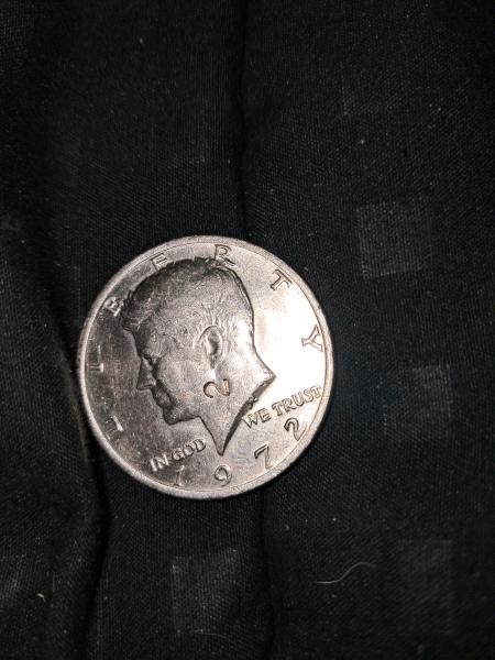 1972 half dollar with a 2 imprinted in the neck.