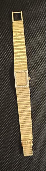 Women’s 14k gold omega watch diamond bezel