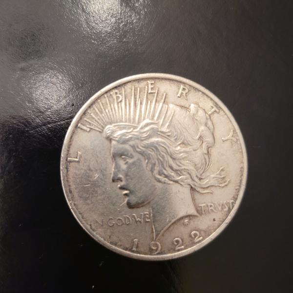 A silver 1922 dollar coin.
